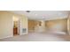 Large bonus room featuring neutral walls and carpet, and a bathroom doorway at 31331 Anniston Dr, Wesley Chapel, FL 33543
