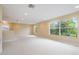 Spacious bonus room with neutral carpet and multiple windows with treed view at 31331 Anniston Dr, Wesley Chapel, FL 33543