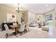 Open concept dining and living room with neutral paint and lots of natural light at 31331 Anniston Dr, Wesley Chapel, FL 33543
