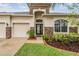 Charming home featuring a well-manicured lawn and a leaded glass front door at 31331 Anniston Dr, Wesley Chapel, FL 33543
