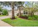 Charming home featuring a well-manicured lawn, mature tree, and three-car garage at 31331 Anniston Dr, Wesley Chapel, FL 33543
