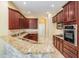 Well-appointed kitchen boasts granite countertops, stainless steel appliances, and ample cabinet space at 31331 Anniston Dr, Wesley Chapel, FL 33543