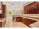Spacious kitchen with granite counters seamlessly transitions into a large living area with many windows at 31331 Anniston Dr, Wesley Chapel, FL 33543