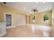 Spacious light-filled living area features tile flooring, a ceiling fan, and large windows at 31331 Anniston Dr, Wesley Chapel, FL 33543