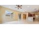 Bright living area with tiled floors features an open floor plan concept and a ceiling fan at 31331 Anniston Dr, Wesley Chapel, FL 33543