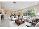 Open-concept living room with neutral tones, ample seating and dining area at 31331 Anniston Dr, Wesley Chapel, FL 33543