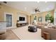 Comfortable living room is styled with neutral decor, modern furnishings, and a large area rug at 31331 Anniston Dr, Wesley Chapel, FL 33543