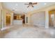 Spacious living area with light tiled floors features an open concept and decorative stonework at 31331 Anniston Dr, Wesley Chapel, FL 33543