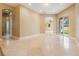 Spacious living room boasts tile flooring, slider doors to the yard, and plentiful natural light at 31331 Anniston Dr, Wesley Chapel, FL 33543