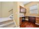 Bright office with desk and storage cabinets, adjacent to carpeted stairs at 31331 Anniston Dr, Wesley Chapel, FL 33543