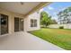 Covered patio overlooking a manicured lawn and private backyard at 31331 Anniston Dr, Wesley Chapel, FL 33543