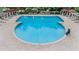Areal view of a large community pool surrounded by lounge chairs and pergola covered seating areas at 31331 Anniston Dr, Wesley Chapel, FL 33543