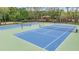Two tennis courts with green and blue surfaces, ready for a match at 31331 Anniston Dr, Wesley Chapel, FL 33543