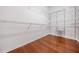 Walk-in closet with custom shelving and hardwood floors, ready for organization at 31331 Anniston Dr, Wesley Chapel, FL 33543