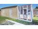 Backyard with a large white screened enclosure or a shed, ideal for pets or storage at 3209 W Tyson Ave, Tampa, FL 33611