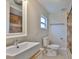 Bright bathroom features a modern sink, neutral tile, and natural light from a window at 3209 W Tyson Ave, Tampa, FL 33611