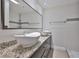 Modern bathroom featuring double sink vanity, updated fixtures and a walk-in shower at 3209 W Tyson Ave, Tampa, FL 33611