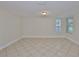 Bright bedroom featuring tile floors, a neutral palette, and well-lit windows at 3209 W Tyson Ave, Tampa, FL 33611
