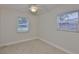 Sunlit bedroom with tile floors, two large windows and neutral colored walls, creating a bright open space at 3209 W Tyson Ave, Tampa, FL 33611