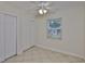 Bedroom with tile floors, large closet, neutral walls, and bright natural light from the window at 3209 W Tyson Ave, Tampa, FL 33611