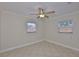 Neutral bedroom with tile floor features two windows and ceiling fan at 3209 W Tyson Ave, Tampa, FL 33611