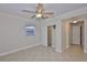 Neutral bedroom offers an open closet and access to a private bathroom at 3209 W Tyson Ave, Tampa, FL 33611