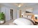 Sunlit bedroom with closet space, tile flooring, and minimalist decor at 3209 W Tyson Ave, Tampa, FL 33611