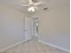 Neutral bedroom with tile floor features two windows and ceiling fan at 3209 W Tyson Ave, Tampa, FL 33611