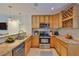 Well-equipped kitchen with stainless steel appliances and tan granite countertops at 3209 W Tyson Ave, Tampa, FL 33611