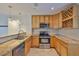 Well-equipped kitchen with stainless steel appliances and tan granite countertops at 3209 W Tyson Ave, Tampa, FL 33611