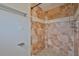 Tiled shower boasts earth-tone accents and tiled floor, complemented by brushed-metal fixtures at 3209 W Tyson Ave, Tampa, FL 33611