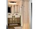 Bathroom featuring dual sinks, a vanity with storage, and stylish mirrors at 34 Harbor Oaks Cir, Safety Harbor, FL 34695