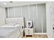 This is a bedroom with wood floor, gray accent wall with white trim, and bed with neutral color bedding at 34 Harbor Oaks Cir, Safety Harbor, FL 34695