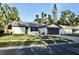 Beautiful single story home featuring an attached two-car garage and a lush green lawn at 34 Harbor Oaks Cir, Safety Harbor, FL 34695