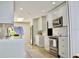 Well-lit modern kitchen with stainless steel appliances, white cabinets, and skylight at 34 Harbor Oaks Cir, Safety Harbor, FL 34695