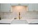 Modern kitchen with a stylish faucet, white countertops, and mosaic tile backsplash at 34 Harbor Oaks Cir, Safety Harbor, FL 34695