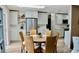 Open kitchen and dining area with stainless steel refrigerator, white cabinets, and wooden flooring at 34 Harbor Oaks Cir, Safety Harbor, FL 34695