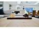 Open-concept living room featuring a stone fireplace, comfortable seating, and natural light with a chessboard at 34 Harbor Oaks Cir, Safety Harbor, FL 34695