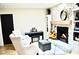 Inviting living room features a stone fireplace, built-in shelving, piano, and comfortable seating at 34 Harbor Oaks Cir, Safety Harbor, FL 34695