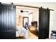 Main bedroom with sliding barn doors, ceiling fan and dresser at 34 Harbor Oaks Cir, Safety Harbor, FL 34695