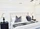 Bright bedroom with a tufted headboard and neutral colored pillows at 34 Harbor Oaks Cir, Safety Harbor, FL 34695