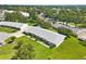 Aerial view of a residential community featuring multiple homes with green lawns and mature trees at 3410 Stonehaven E Ct # A, Palm Harbor, FL 34684