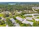 Aerial view of a residential area featuring tree-lined streets, community buildings, and scenic views at 3410 Stonehaven E Ct # A, Palm Harbor, FL 34684