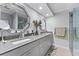 Elegant bathroom featuring double vanity with granite countertops and modern fixtures at 3410 Stonehaven E Ct # A, Palm Harbor, FL 34684