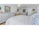 Bright bedroom featuring light gray walls, a ceiling fan, and a comfortable bed with white bedding at 3410 Stonehaven E Ct # A, Palm Harbor, FL 34684