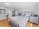 Light and airy bedroom featuring light gray walls, hardwood floors, and a decorative ceiling fan at 3410 Stonehaven E Ct # A, Palm Harbor, FL 34684