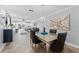 Open-concept dining room with modern chandelier and seating for six at 3410 Stonehaven E Ct # A, Palm Harbor, FL 34684