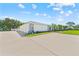 Villa featuring driveway parking, well-maintained landscaping, and inviting curb appeal at 3410 Stonehaven E Ct # A, Palm Harbor, FL 34684