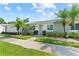 Inviting villa featuring lush landscaping, vibrant green lawn and beautiful palm trees at 3410 Stonehaven E Ct # A, Palm Harbor, FL 34684