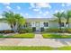 Beautiful villa featuring mature palm trees, lush green lawn and a well-manicured landscape at 3410 Stonehaven E Ct # A, Palm Harbor, FL 34684